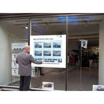 Multi touch foil being used by a man in a car dealership