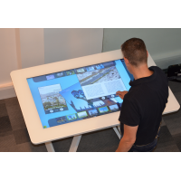 A man using a projected capacitive touch film interactive table