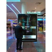 A man using an interactive digital signage totem from VisualPlanet