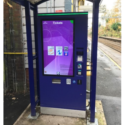 A self-service ticket machine with a thick glass touch screen