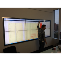 A man using a pro cap touch screen in a meeting room