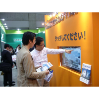 Two men using a touch screen with interactive foil