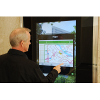 A man using a wayfinding self service touch screen kiosk