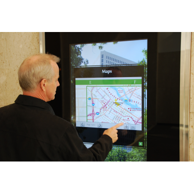 A man using an interactive wayfinding kiosk