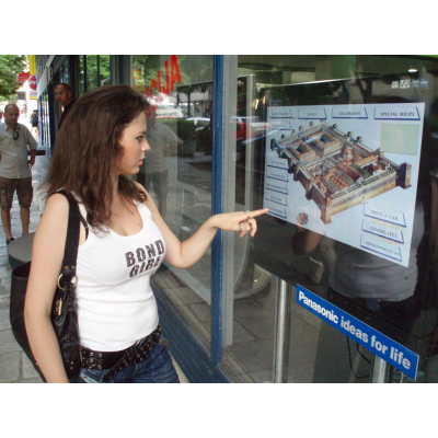 Girl using touch screen with interactive foil