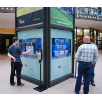 People using an interactive wayfinding kiosk in a shopping centre