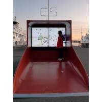 A woman using a PCAP interactive wayfinding kiosk