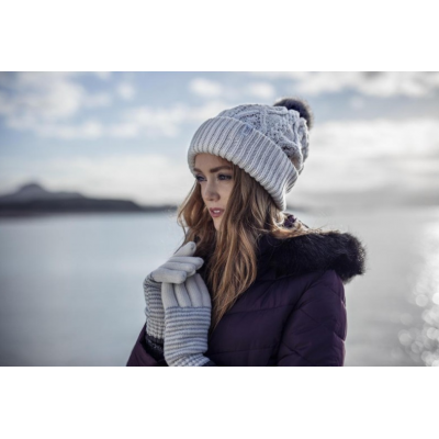 A woman wearing hat and gloves from HeatHolders: the leading thermal clothes supplier.