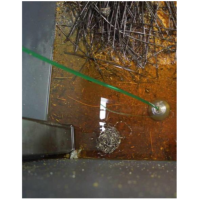 Machine cutting fluid recycling system in use in a swarf bin.