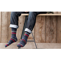 A man wearing striped socks from the leading quality sock supplier.