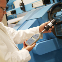 A worker calibrating his noise monitoring equipment.