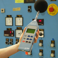 A worker using a professional noise measuring device.