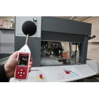 Bluetooth decibel meter being used for industrial noise assessment.