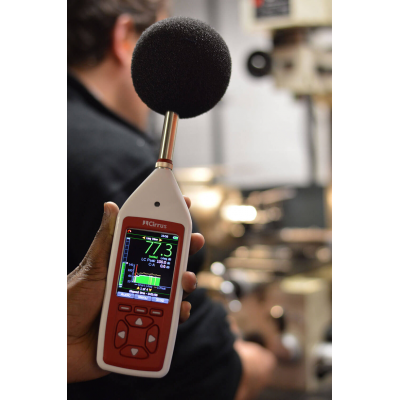 workplace noise monitoring equipment in a factory taking a reading