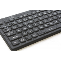 illuminated keyboard close up and wet