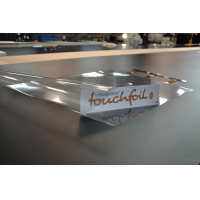 Touch foil for glass converts a glass panel into a touch sensitive surface.
